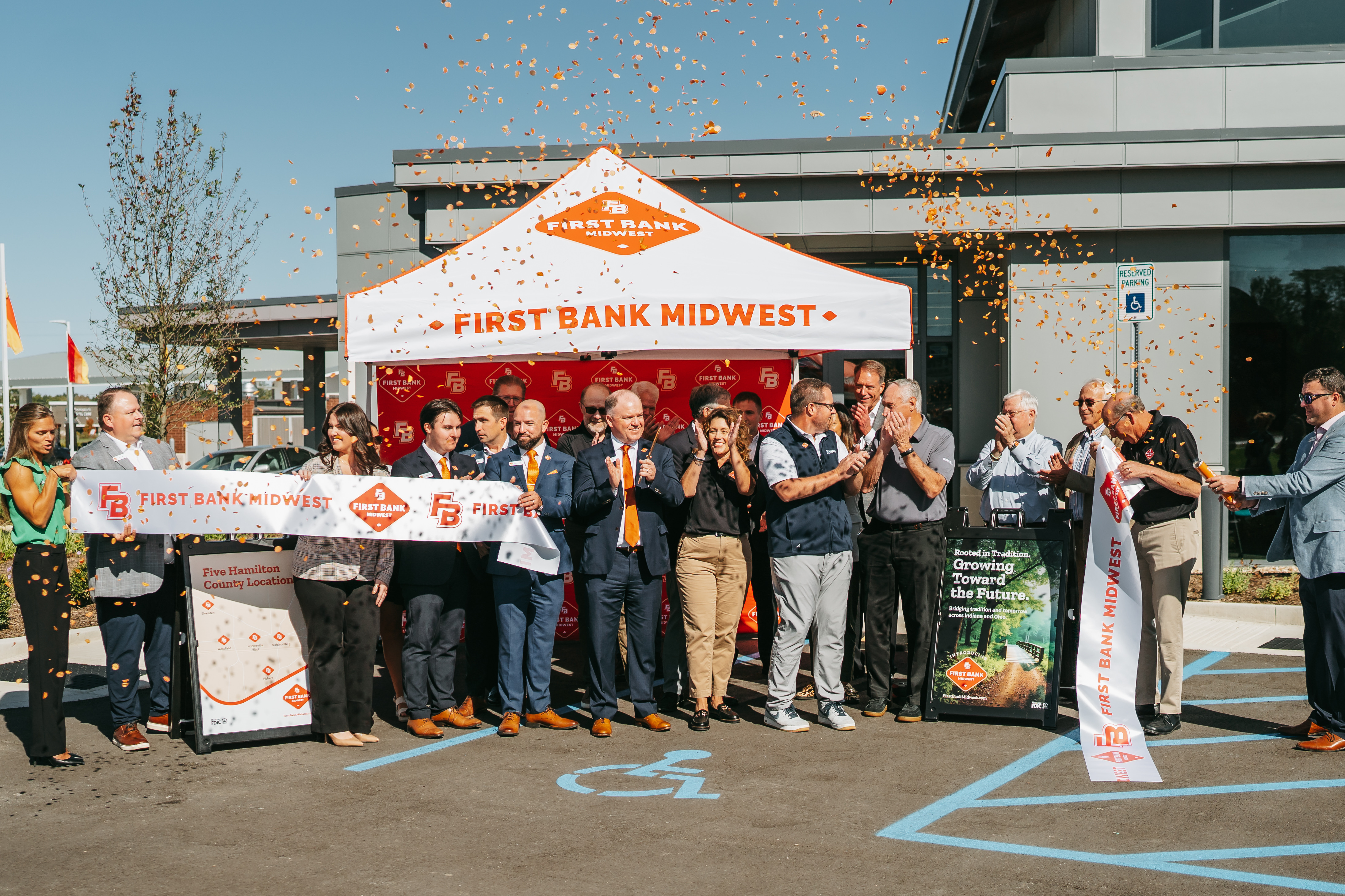 Photo of First Bank Midwest staff cutting ribbon at Noblesville West Grand Opening